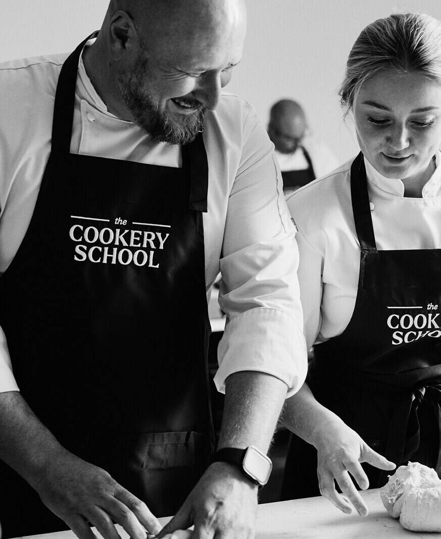 Hands shaping dough at the Cookery School